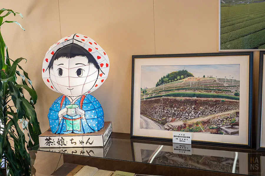 造型可愛的茶娘燈籠與描繪石牆茶園的優美畫作